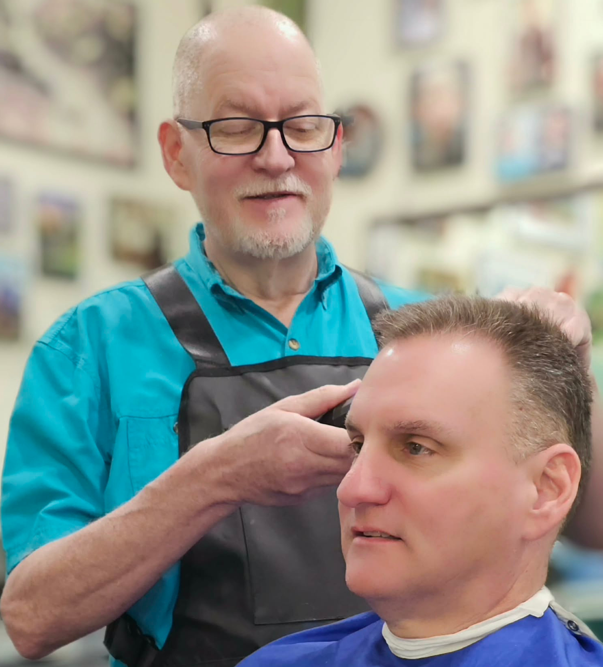 Phil - 2nd in command - in action! He's giving a young man a nice combover.